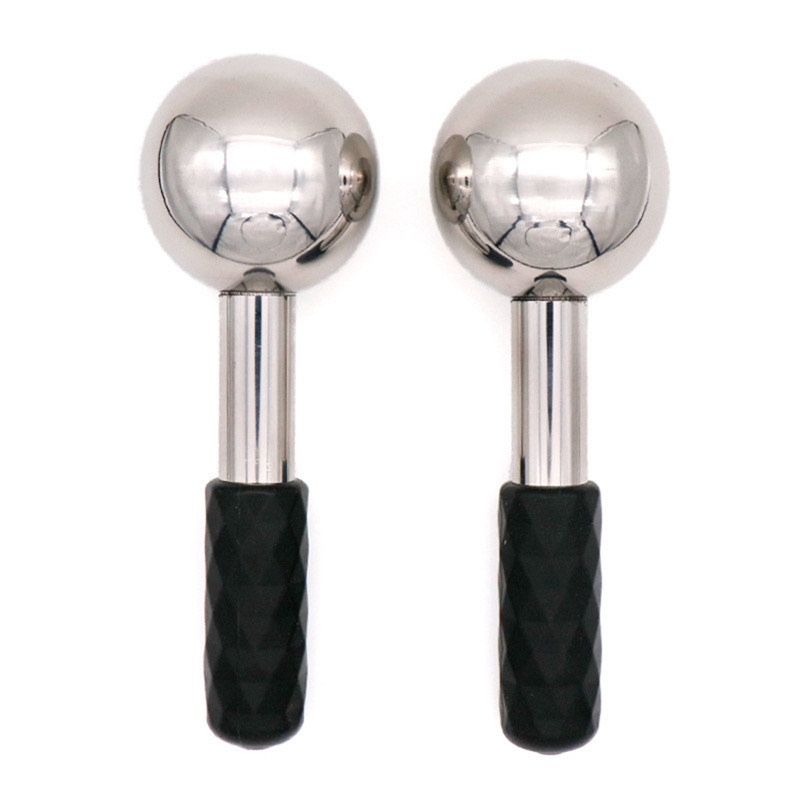 Pair of polished stainless steel cryo facial globes with black textured grip handles